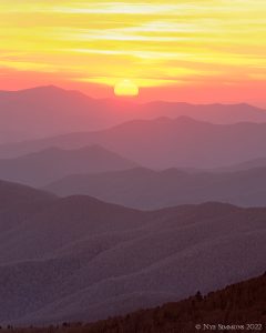 The classic view of the setting sun over stacked ridges occurs at Clingmans Dome in the fall.
