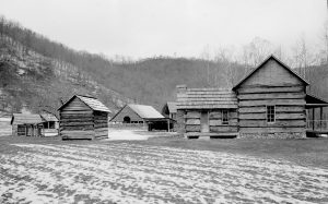 What is now the Mountain Farm Museum near the Oconaluftee entrance to the national park as captured by Henry Lix. At this location and elsewhere in the park by the mid-1950s, park visitors could peruse racks of informational books, postcards, and brochures—some of them printed by the Great Smoky Mountains History Association that Henry Lix helped to create. Provided by GSMNP archives.