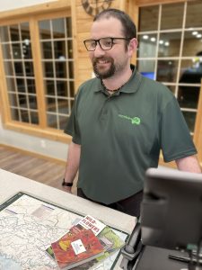 Smokies Life Sales Assistant Joe McBrien rings up a customer at the new Great Smokies Welcome Center in Townsend, Tennessee. Apparel and products featuring the Smokies Life logo are available for purchase at all Smokies Life visitor centers beginning February 1.